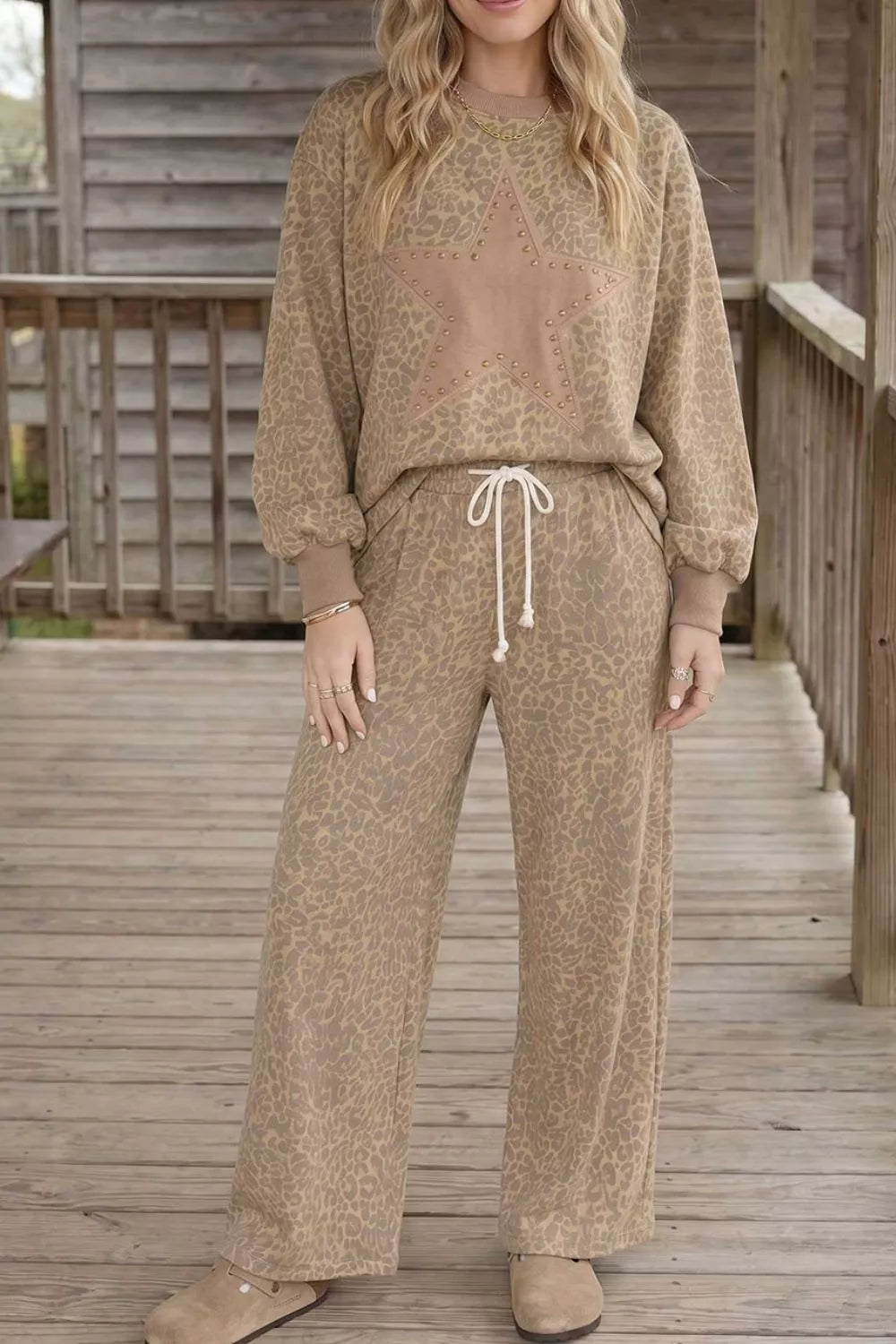 Leopard print star embellished sweatshirt and pants set by Trendsi, featuring a stylish animal print design and star details.