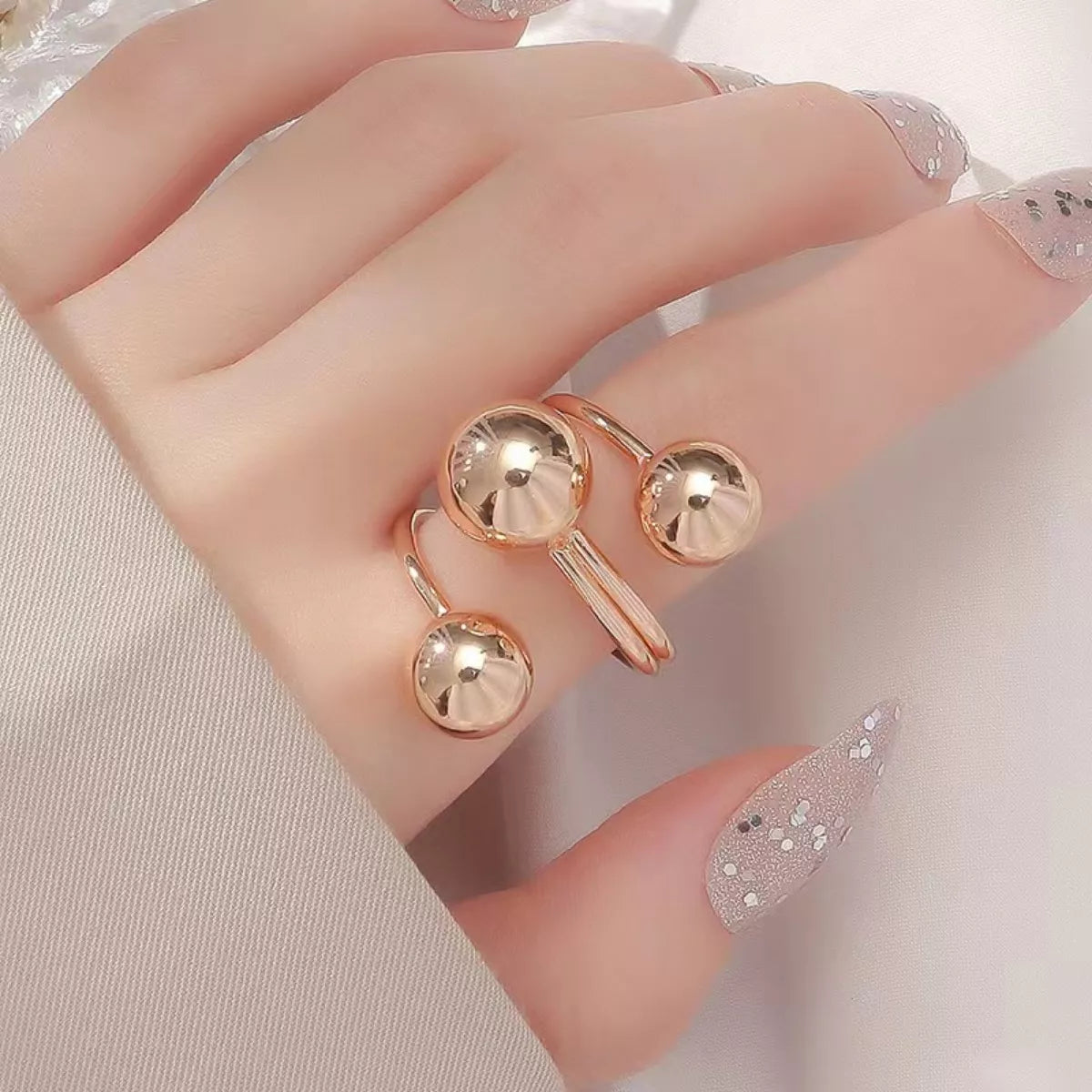 Multi-layered ball ring from Plush Fashion Hub featuring stacked silver-tone rings with textured ball accents.