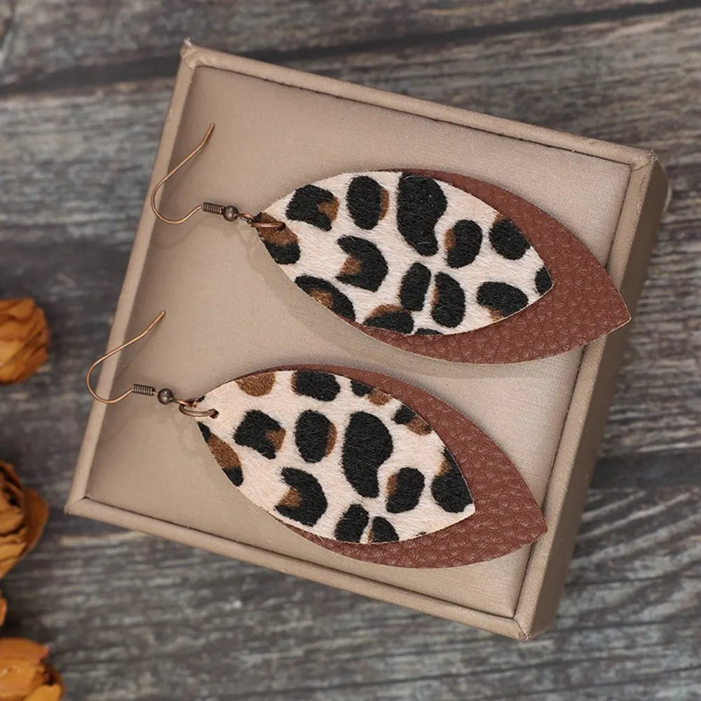 Leaf shape leather dangle earrings by Shopimist featuring natural leather leaves hanging elegantly from hooks.