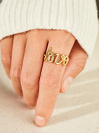 Love 18K gold-plated sterling silver ring with a sleek band, showcasing a shiny finish and elegant design.
