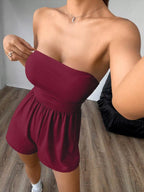 Chic strapless romper with ruched waist, trendy design, shown in a stylish fashion photo, perfect for casual or summer wear.