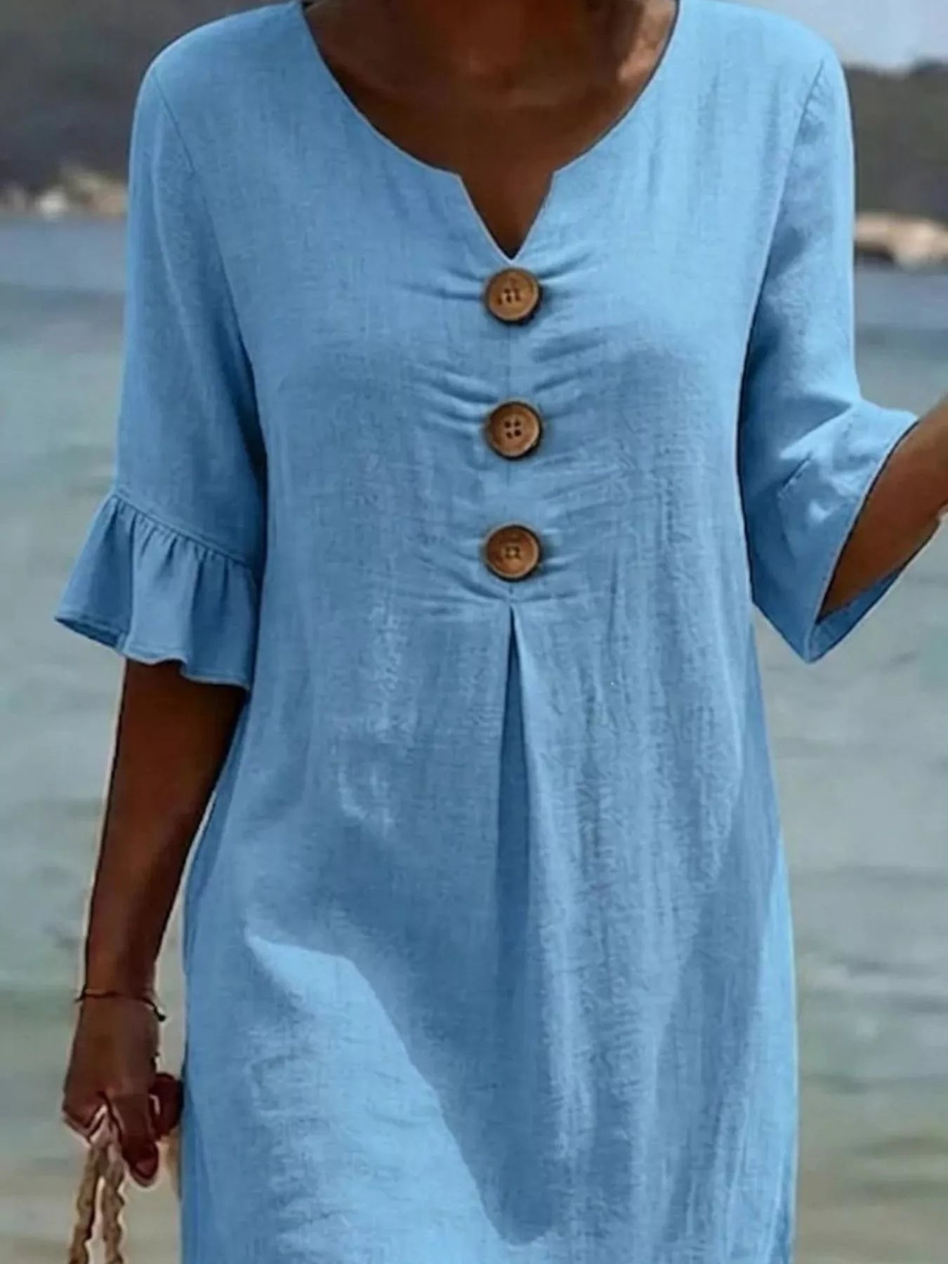Plus size midi dress with button decor and ruffle sleeves, stylish full-size Trendsi dress displayed on a mannequin.