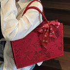 Floral embossed tote handbag by Shopimist with a scarf accent, featuring textured floral pattern and spacious design.