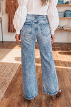 Acid wash flare jeans with pocket details by Shopimist, showing the distressed denim style and high-waist fit.