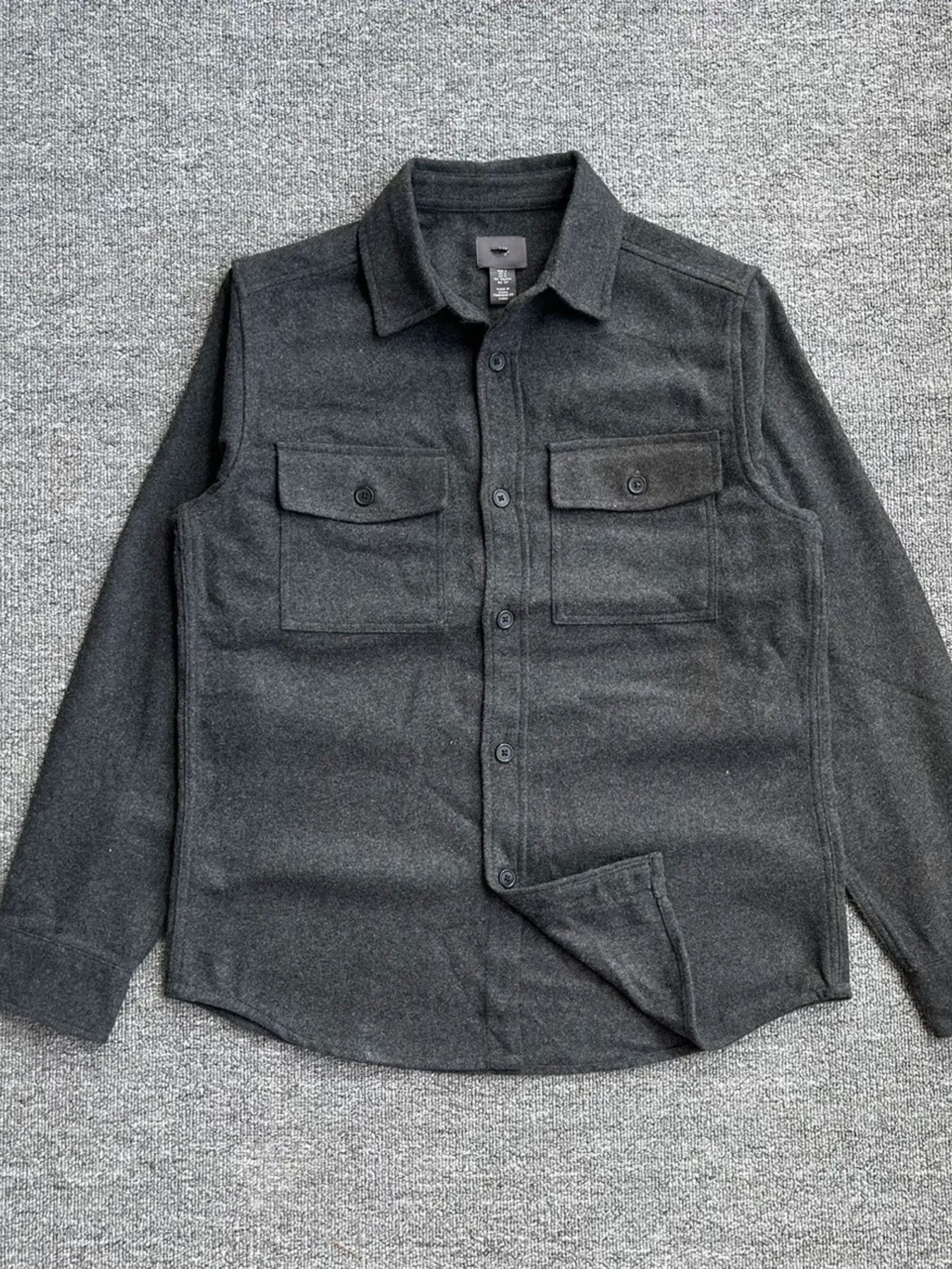 Men's Shopimist button-up long sleeve shacket with a casual fit, featuring a plaid pattern and front button closures.