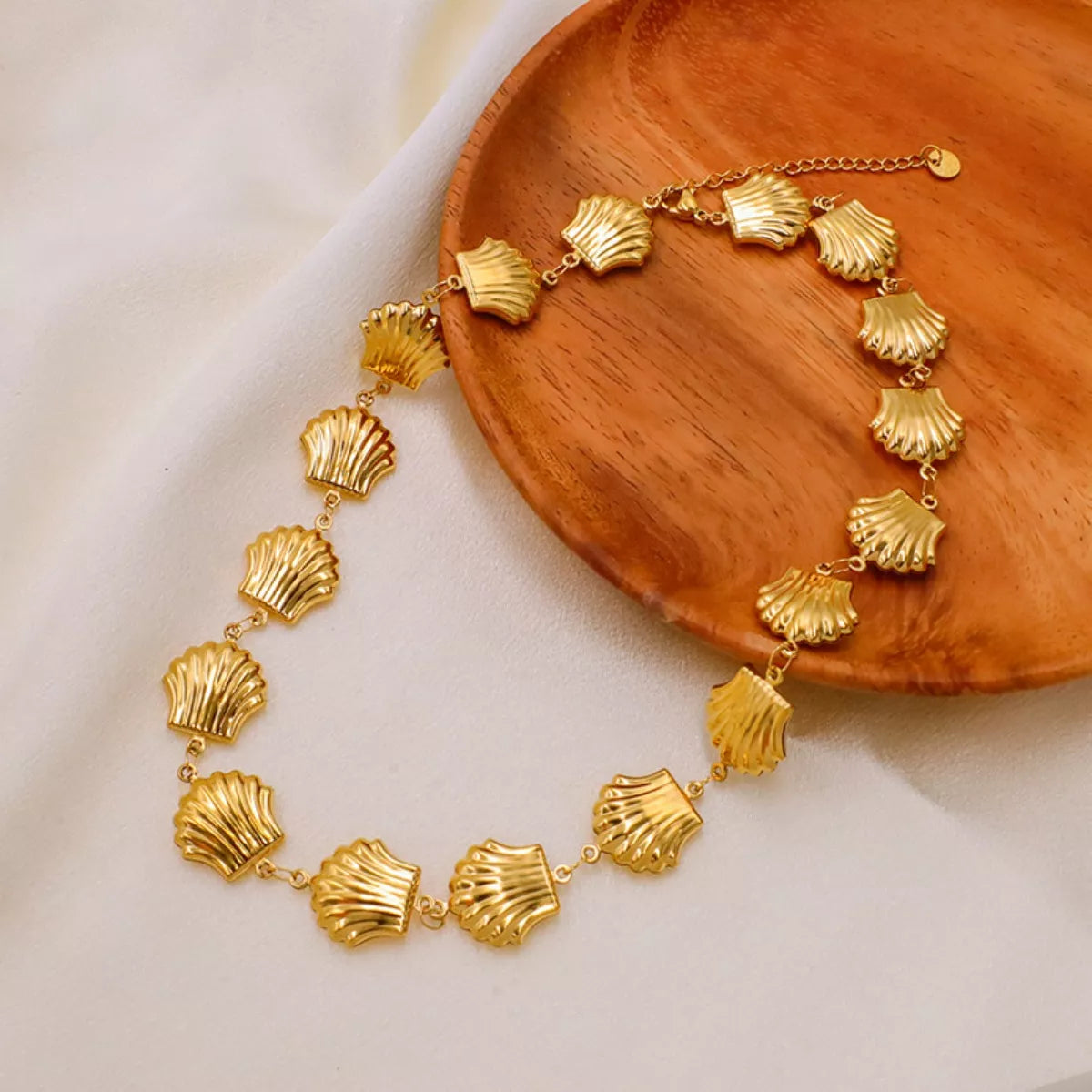 Gold-plated shell necklace from Plush Fashion Hub featuring a delicate ocean-inspired pendant on a fine chain.