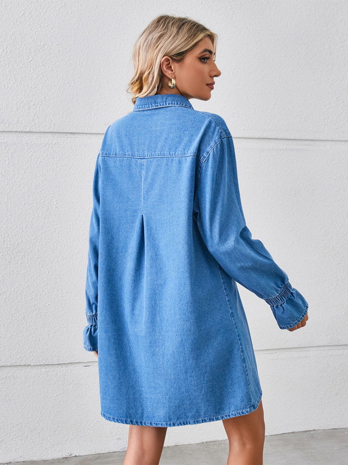 Blue pocketed dropped shoulder mini denim dress by Plush Fashion Hub, showing the casual fit and stylish design.