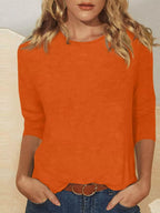 Solid color round neck T-shirt by Trendsi, featuring a classic fit and smooth fabric in a versatile design.