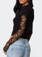 Women's fitted lace sleeve T-shirt by Trendsi featuring elegant lace details and a casual, sophisticated design.
