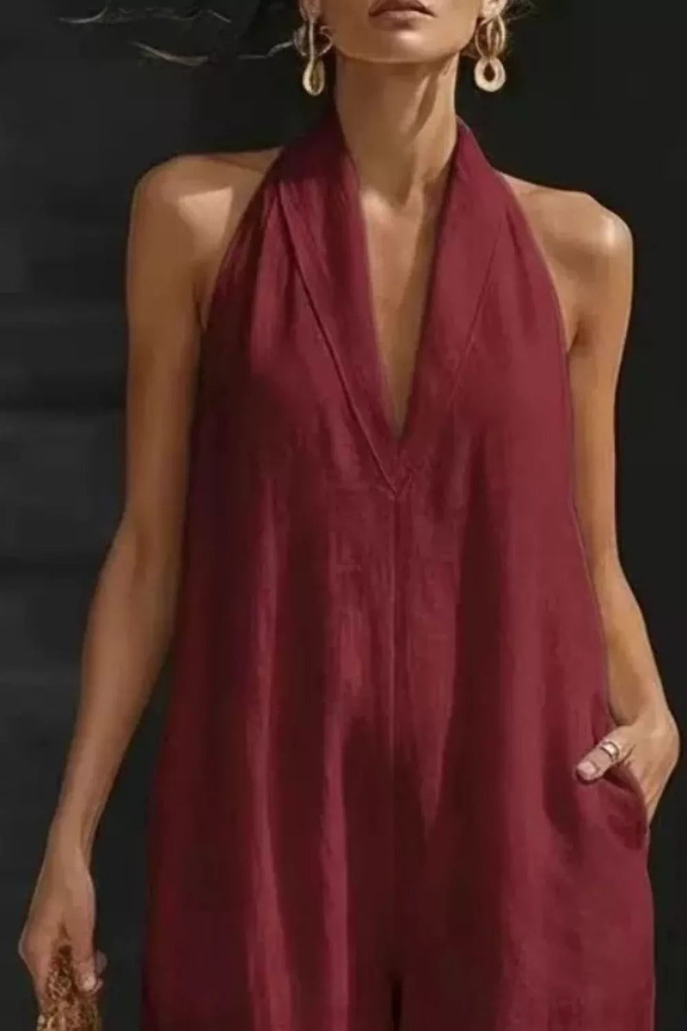 Women's sleeveless wide-leg jumpsuit with pockets, casual chic romper by Trendsi, shown on a model with a relaxed fit and stylish design.