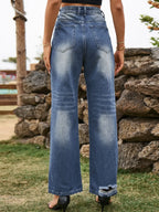 Distressed Plush Fashion Shop denim jeans with ripped details and front pockets, shown on a model.