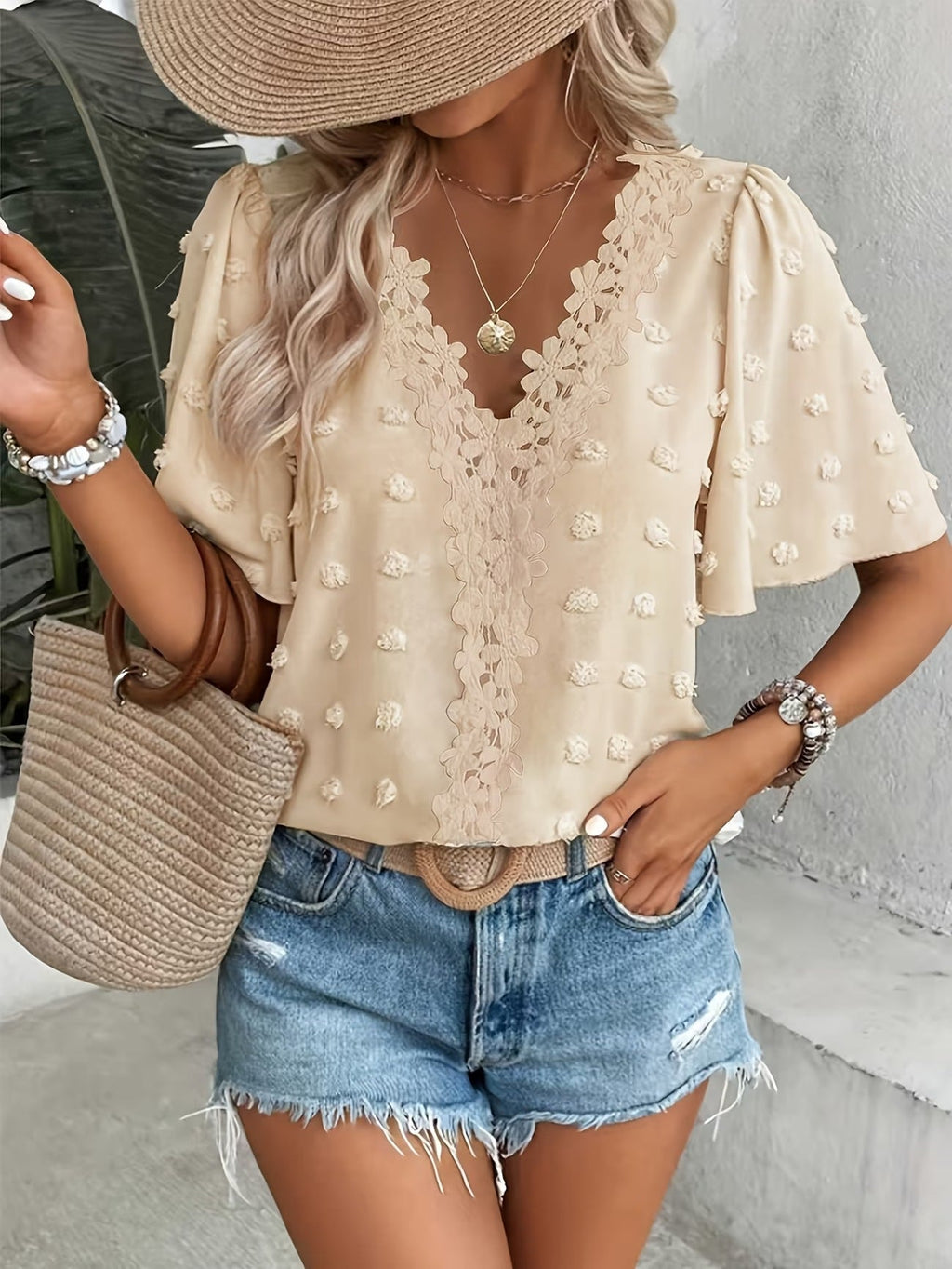 Women's V-neck lace-trim Swiss dot short-sleeve top by Plush Fashion Hub, casual loose-fit blouse with delicate lace accents.