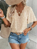 Women's V-neck lace-trim Swiss dot short-sleeve top by Plush Fashion Hub, casual loose-fit blouse with delicate lace accents.
