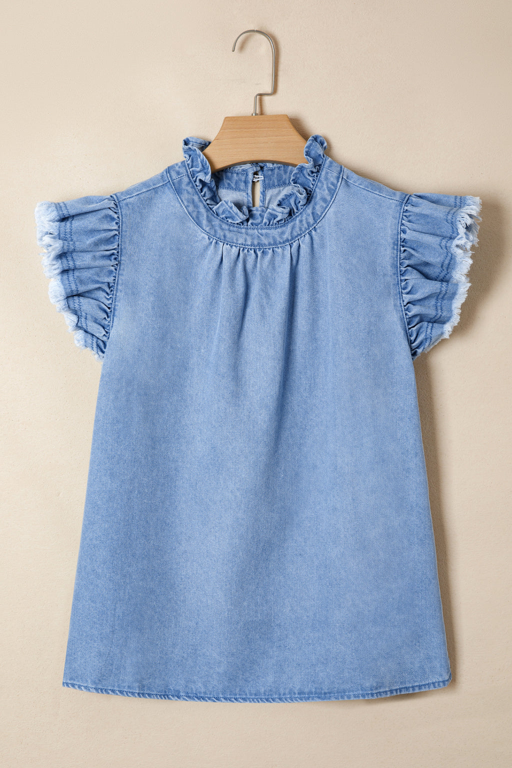 Women's distressed denim top by Trendsi with frilled collar and flutter sleeves, shown in a stylish casual fit.