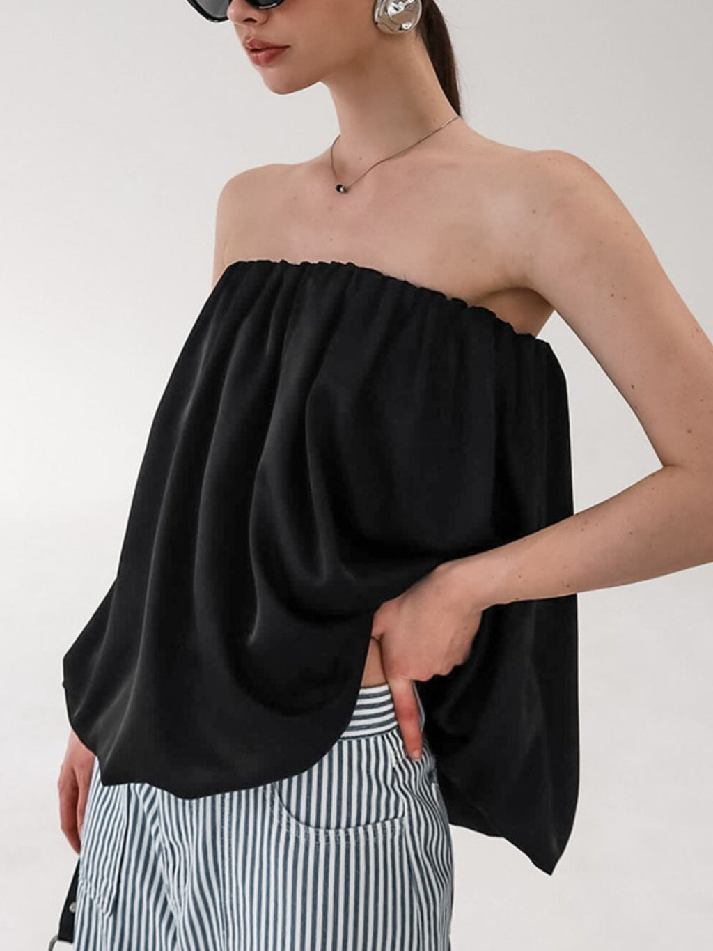 Women's strapless bubble hem tube top by Plush Fashion Hub, sleek minimalist crop top with a fitted silhouette and trendy style.
