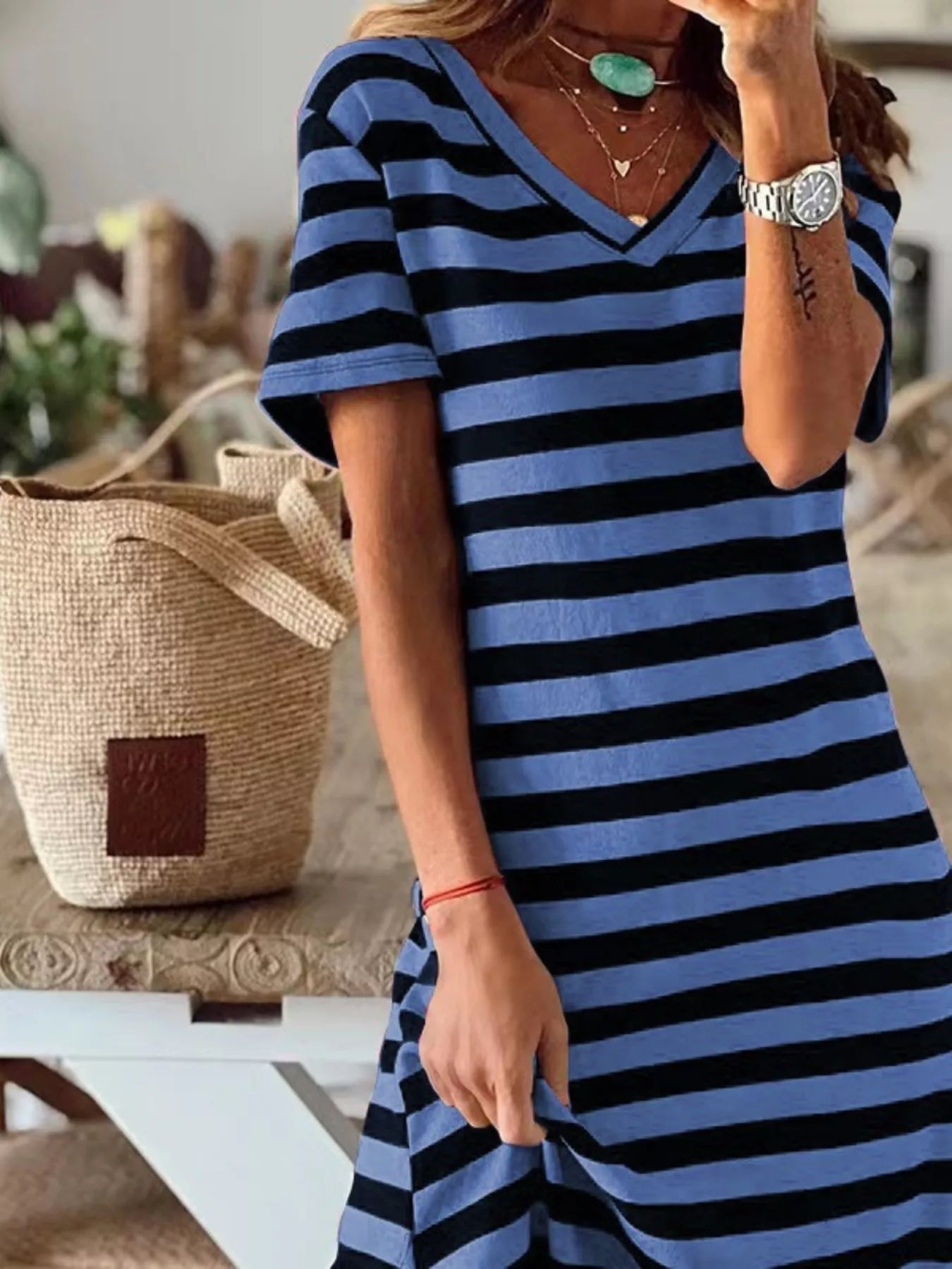 Plus size striped V-neck midi dress with side slit by Trendsi, featuring a full-length design and stylish pattern.
