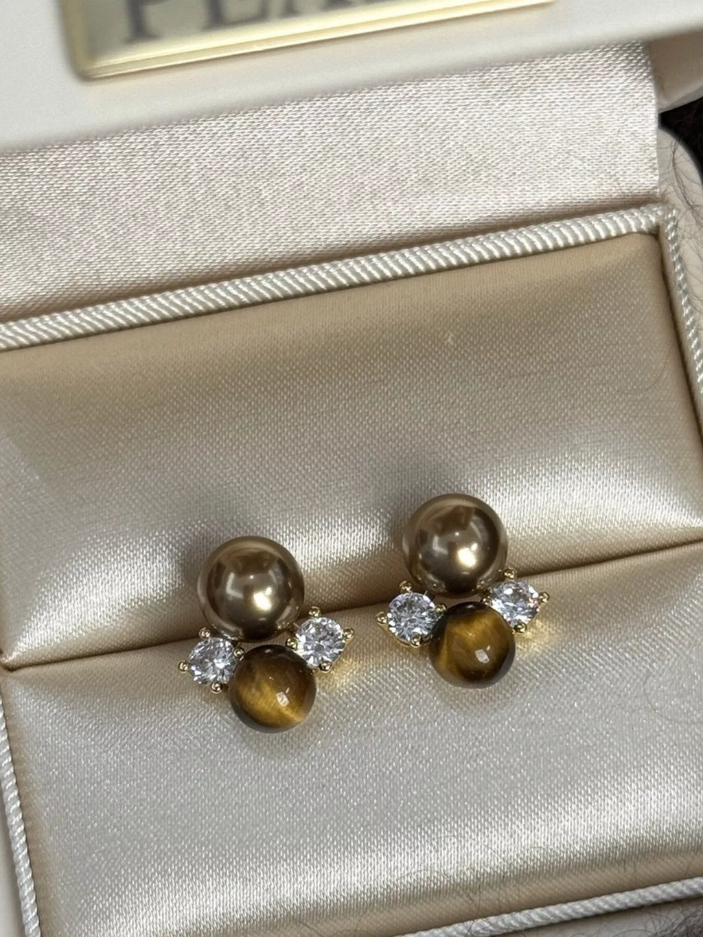 Tiger Eye stud earrings by Trendsi featuring polished, round tiger eye gemstones set in simple metal studs.