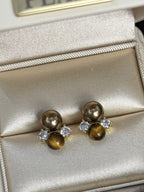 Tiger Eye stud earrings by Trendsi featuring polished, round tiger eye gemstones set in simple metal studs.