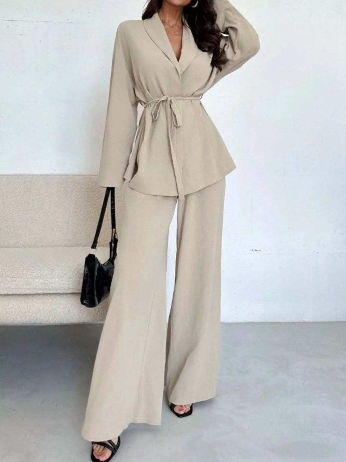 Textured tie waist top and wide-leg pants set for women by Trendsi, featuring a stylish, comfortable matching outfit.