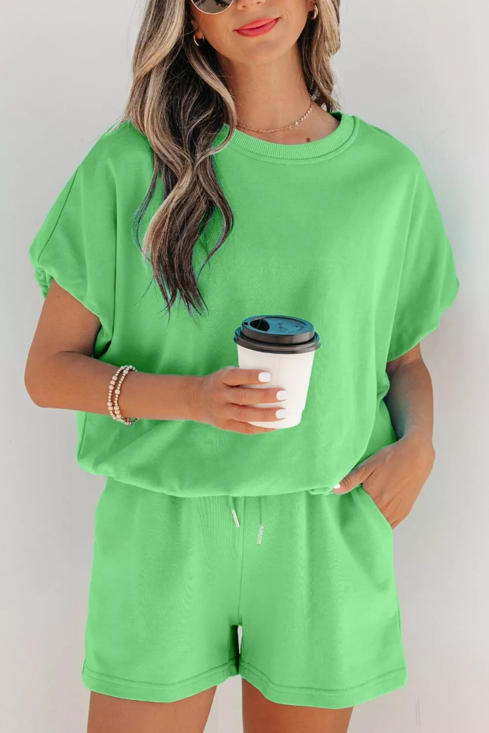 A pair of solid color puffy loose drawstring shorts from Trendsi, shown as part of a stylish 2-piece outfit.