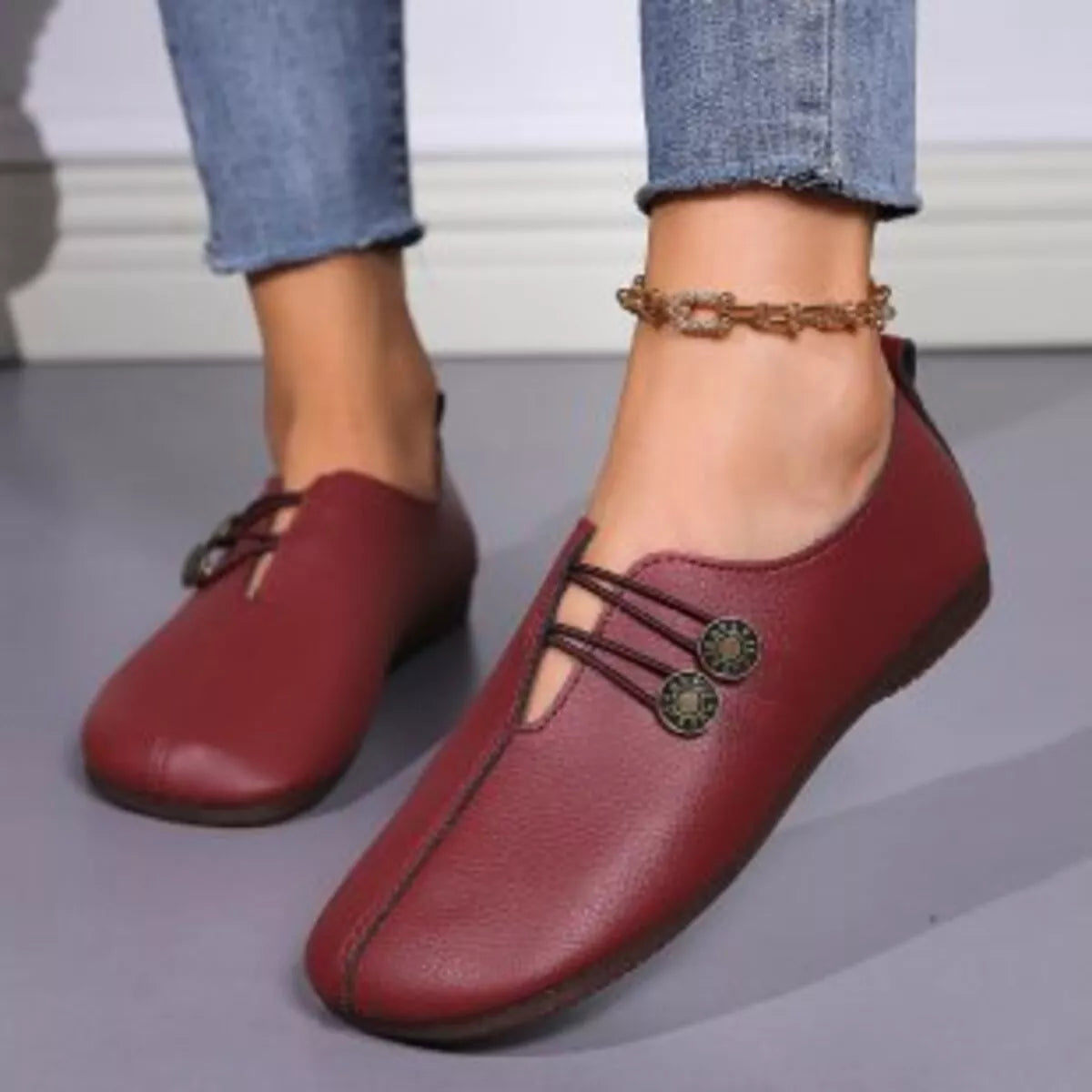 Women's casual slip-on shoes with button details, from Trendsi, featuring a comfortable and stylish design.