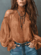 Women's retro cashew print off-shoulder blouse with lantern sleeves, casualwear by Plush Fashion Hub, shown on a model.