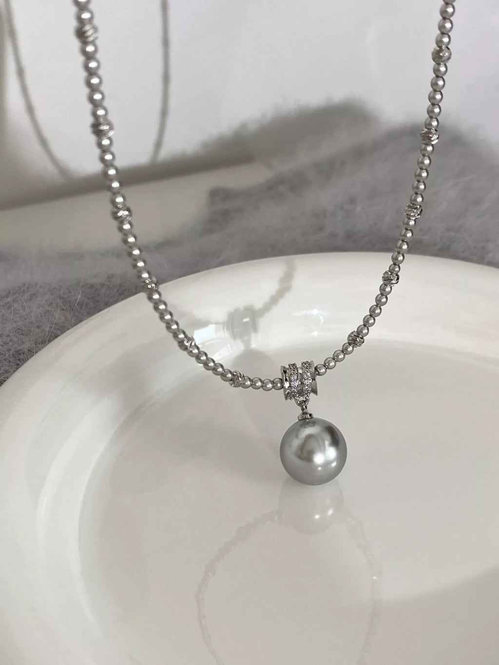 Elegant pearl pendant necklace from Shopimist featuring a single luminous pearl on a delicate chain.