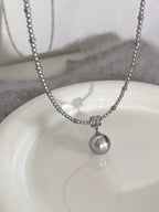 Elegant pearl pendant necklace from Shopimist featuring a single luminous pearl on a delicate chain.