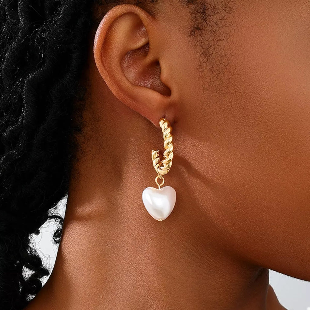 18K gold-plated C-hoop heart earrings with delicate design, featuring shiny heart charms and sleek hoop style.