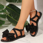 Shopimist bow embellished flat sandals featuring a sleek design, open toe style, and decorative bow detail on the straps.