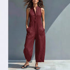 Casual summer sleeveless jumpsuit with V-neck, buttons, pockets, and trousers, worn by a woman, by Plush Fashion Hub.