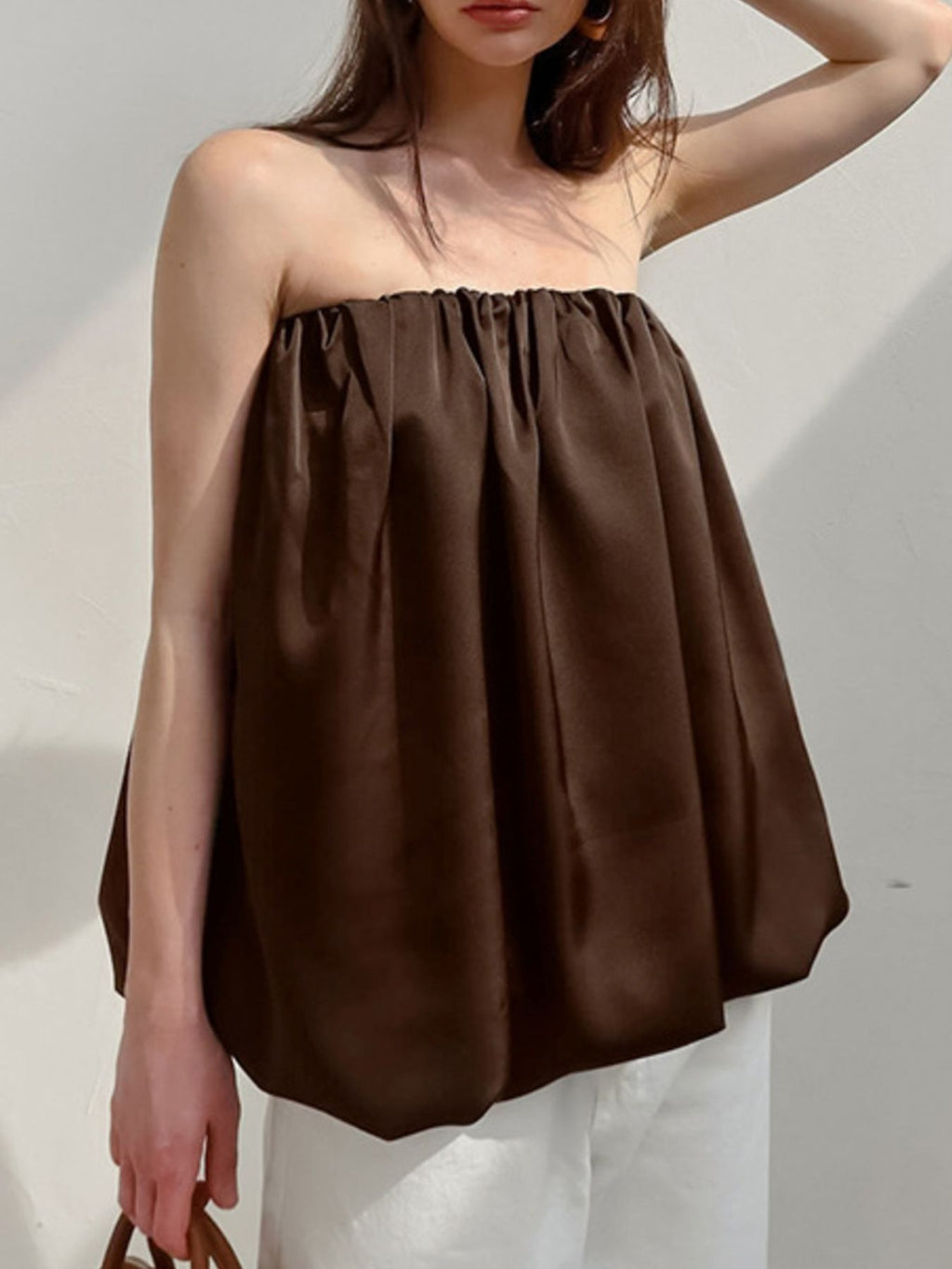 Women's strapless bubble hem tube top by Plush Fashion Hub, sleek minimalist crop top with a fitted style and trendy design.