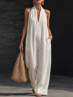 Halter neck wide-leg jumpsuit by Trendsi, featuring a stylish design with a fitted bodice and flowing wide-leg pants.