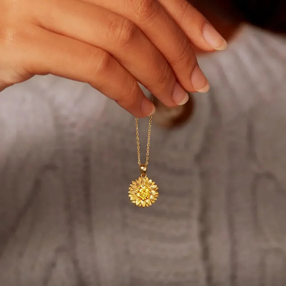 18K gold-plated sunflower-shaped pendant necklace with intricate floral design, hanging on a delicate chain.