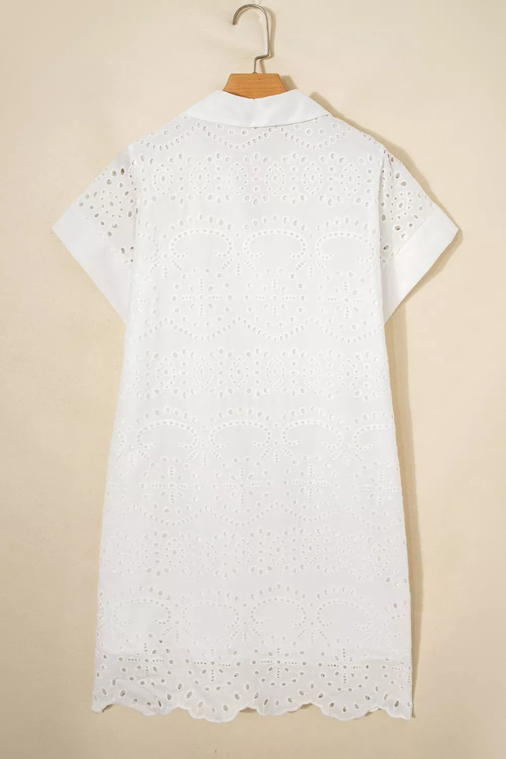 Solid color eyelet embroidered T-shirt mini dress by Trendsi featuring eyelet details and a casual, comfortable fit.