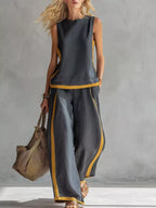 Plus size sleeveless top and wide-leg pants set with contrast stripe design by Plush Fashion Hub, styled for a modern, casual look.