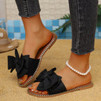 Shopimist bowknot embellished flat sandals with open toes and adjustable ankle straps, featuring stylish bow accents.