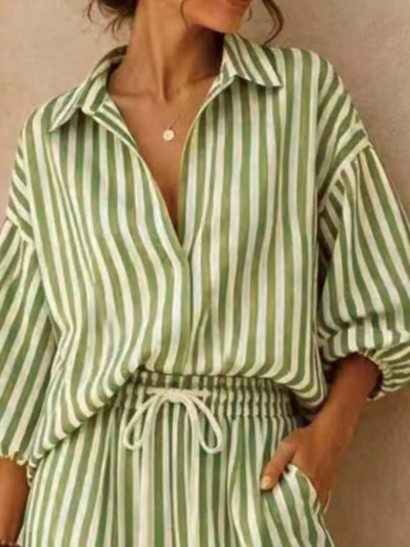 Plus size striped puff sleeve shirt and wide-leg drawstring pants set from Trendsi, featuring a stylish, comfortable matching outfit.