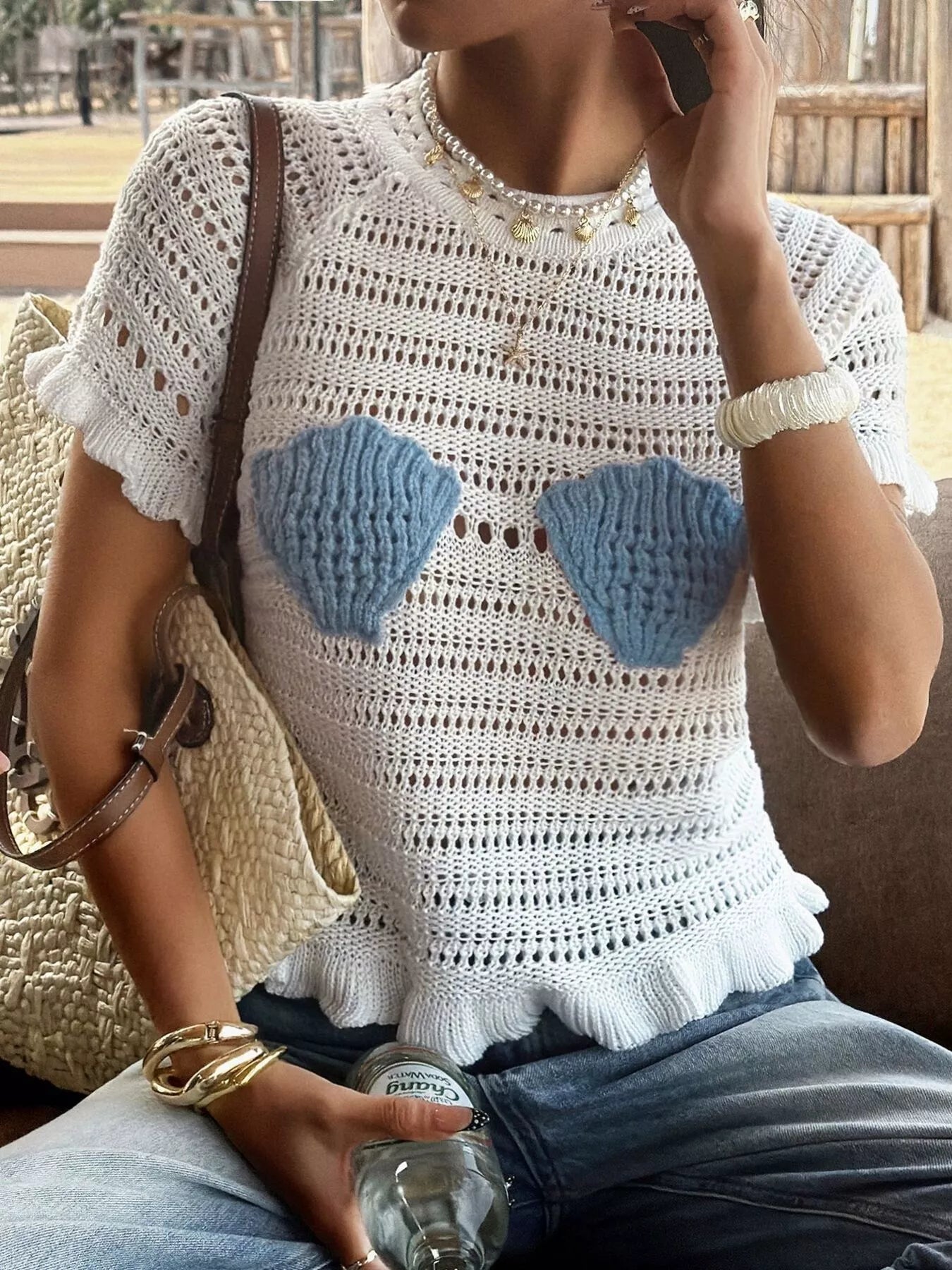 Openwork ruffled hem knit top in a soft, lightweight fabric featuring delicate openwork details and a stylish ruffled hem.