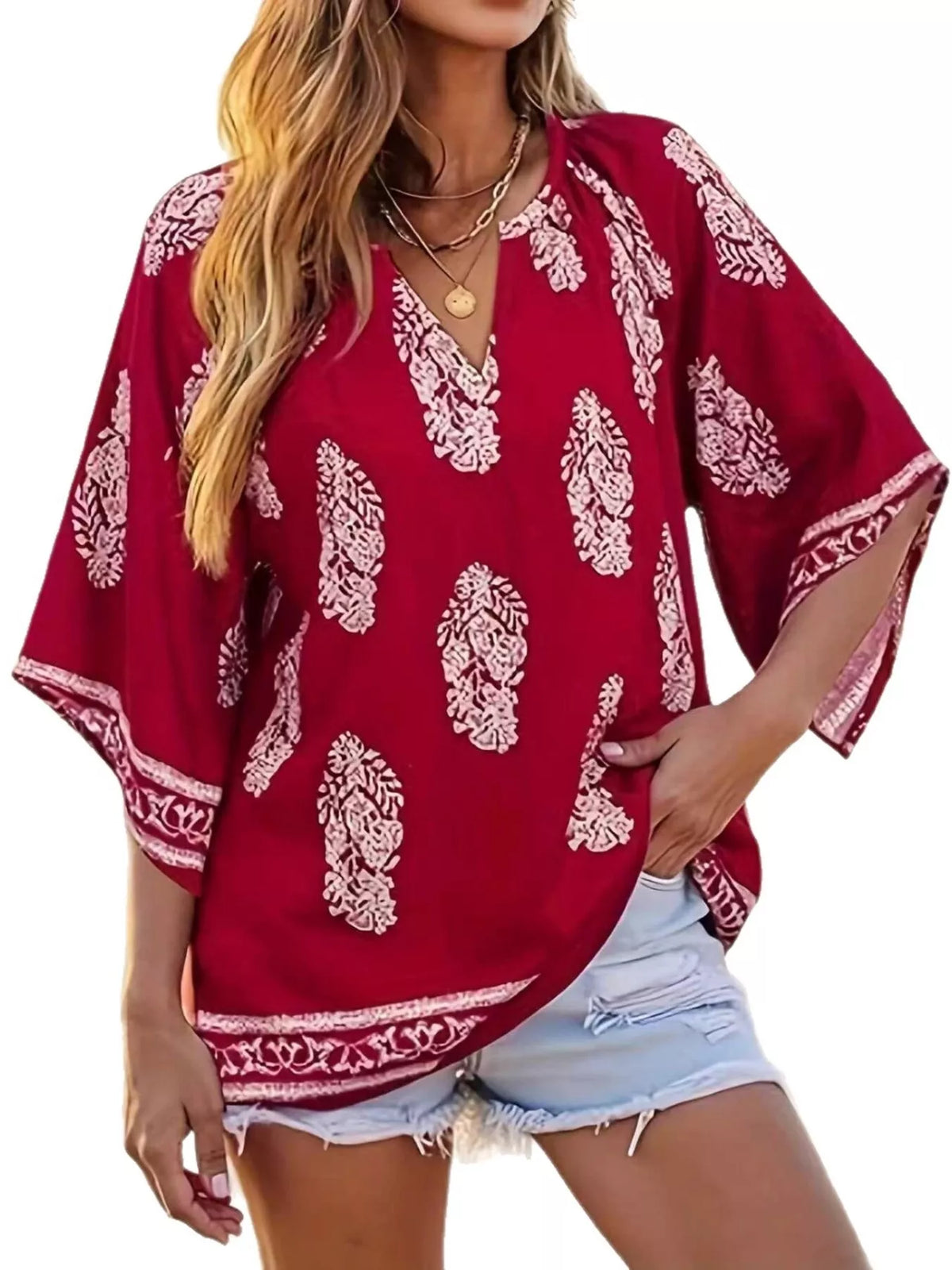 Printed notched 3/4 sleeve blouse by Plush Fashion Hub featuring a stylish design and comfortable fit, shown on a mannequin.