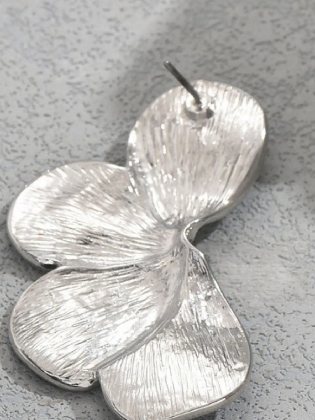 Stainless steel flower earrings from Plush Fashion Hub featuring delicate floral design and shiny metal finish.