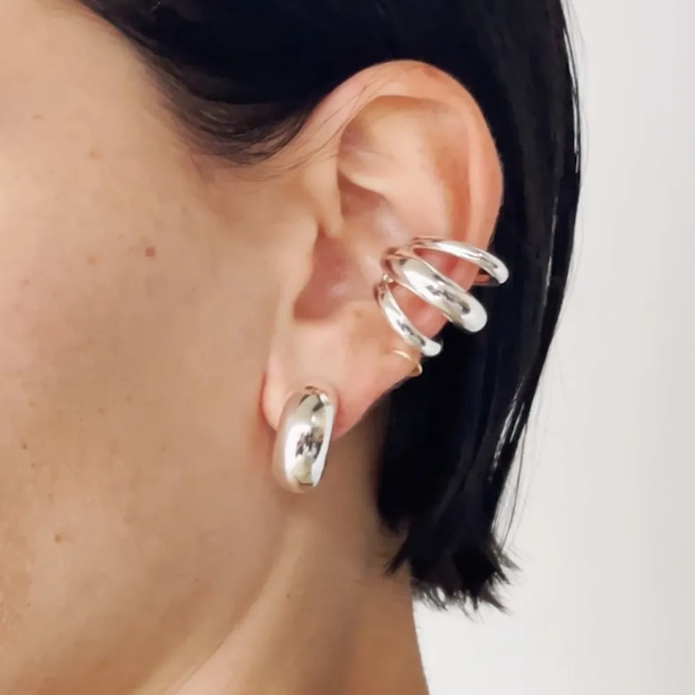 Stainless steel layered cuff earrings from Plush Fashion Hub featuring multiple overlapping circular designs for stylish wear.