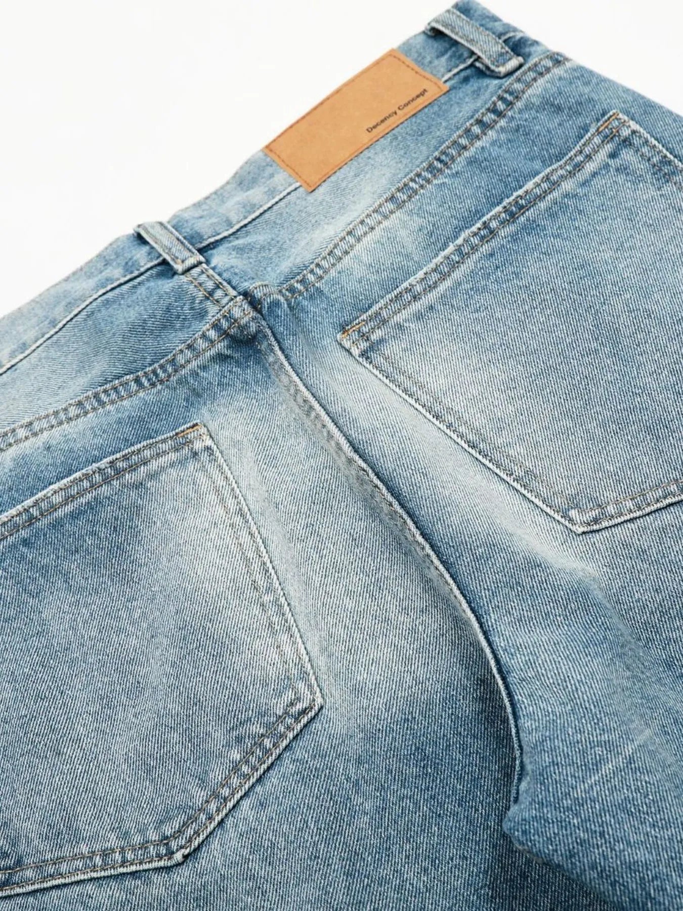 Men's loose fit jeans from Trendsi, casual denim pants with a relaxed fit, shown hanging on a hanger against a neutral background.