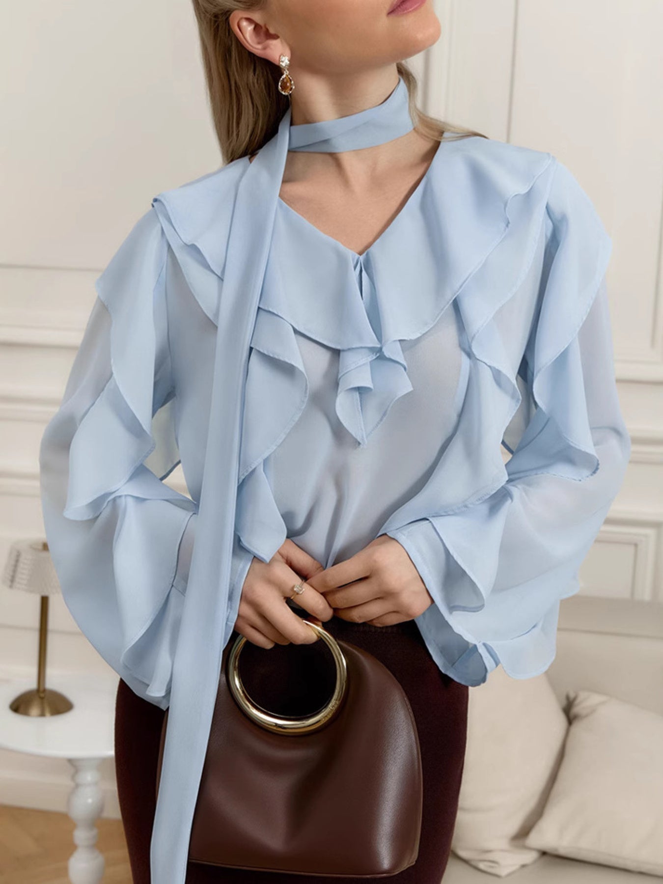 Elegant chiffon blouse with ruffle trim and tie neck detail, stylish and feminine, perfect for casual or dressy occasions.