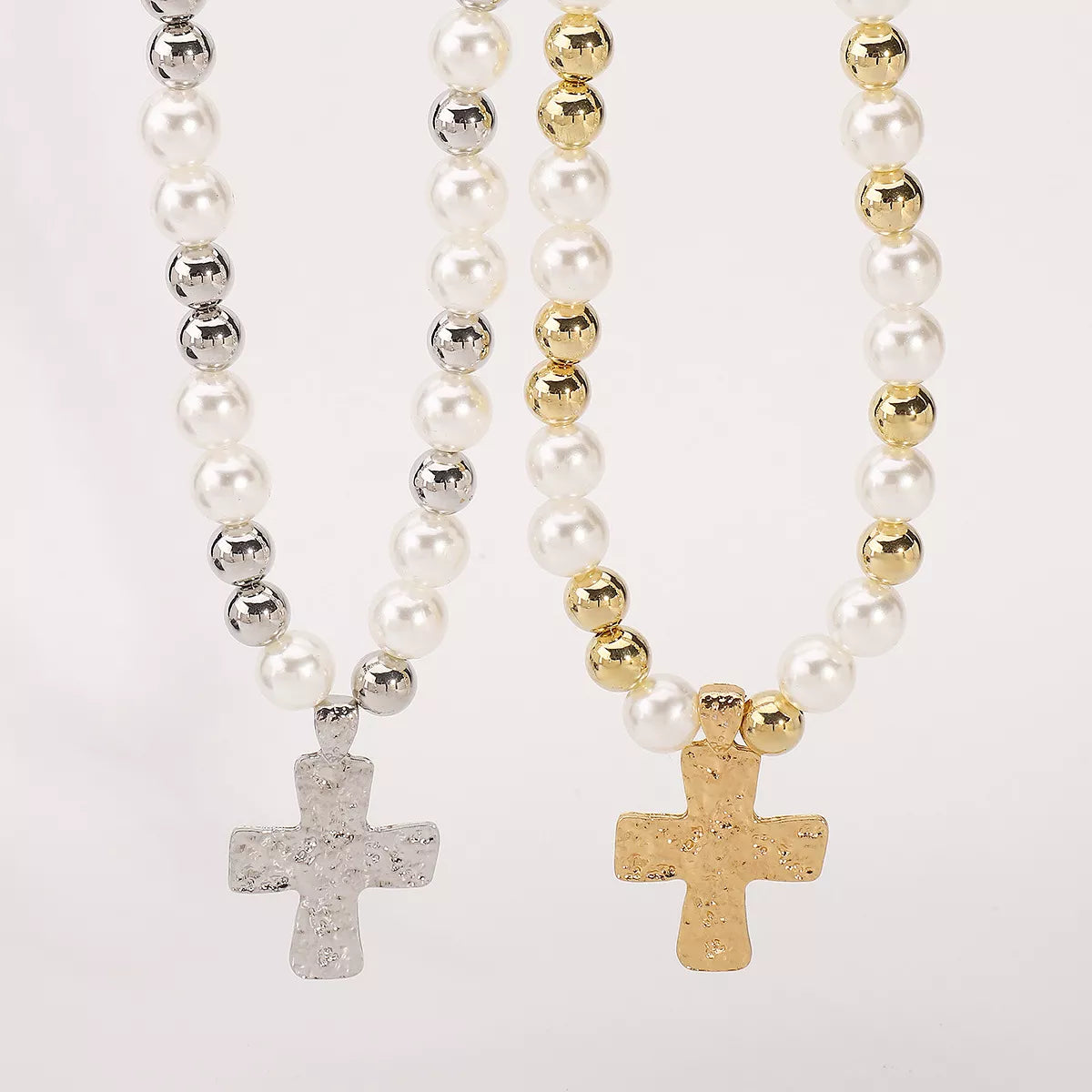Pearl and cross pendant necklace from Plush Fashion Hub featuring a elegant silver chain with a pearl and cross charm.