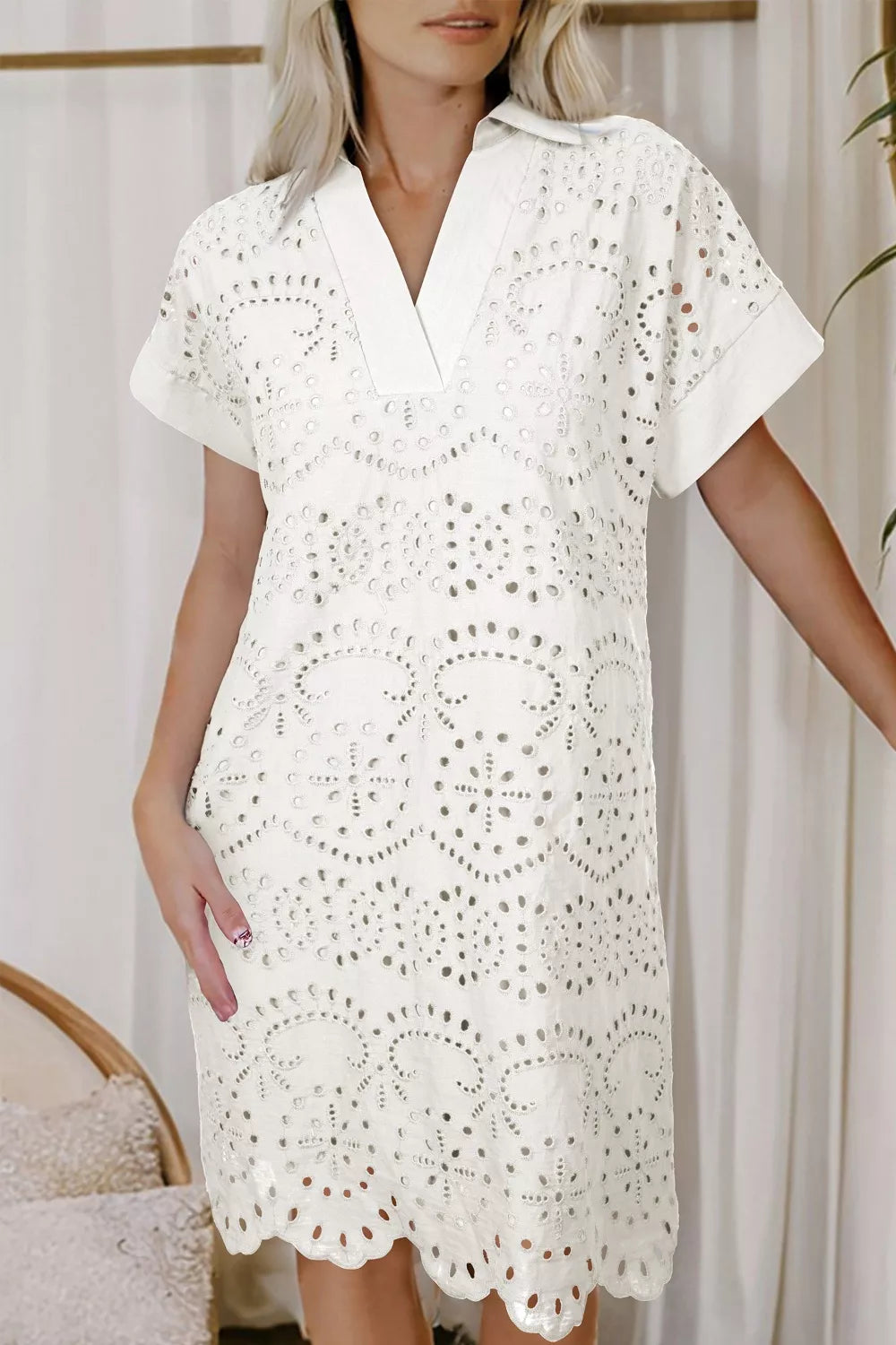 Solid color eyelet embroidered T-shirt mini dress by Trendsi, featuring a relaxed fit and decorative eyelet details.