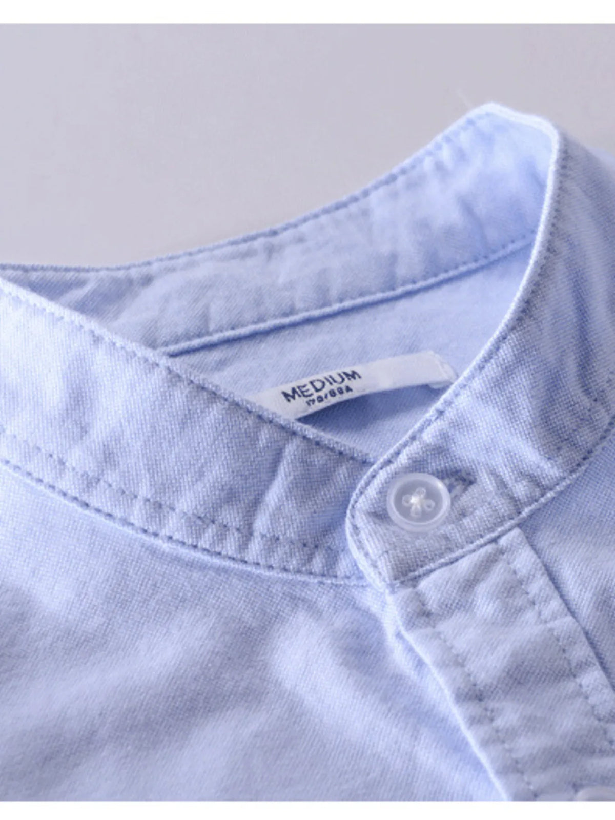 Plus size men's button-up long sleeve shirt by Trendsi, shown in navy with a classic collar and front button closure.