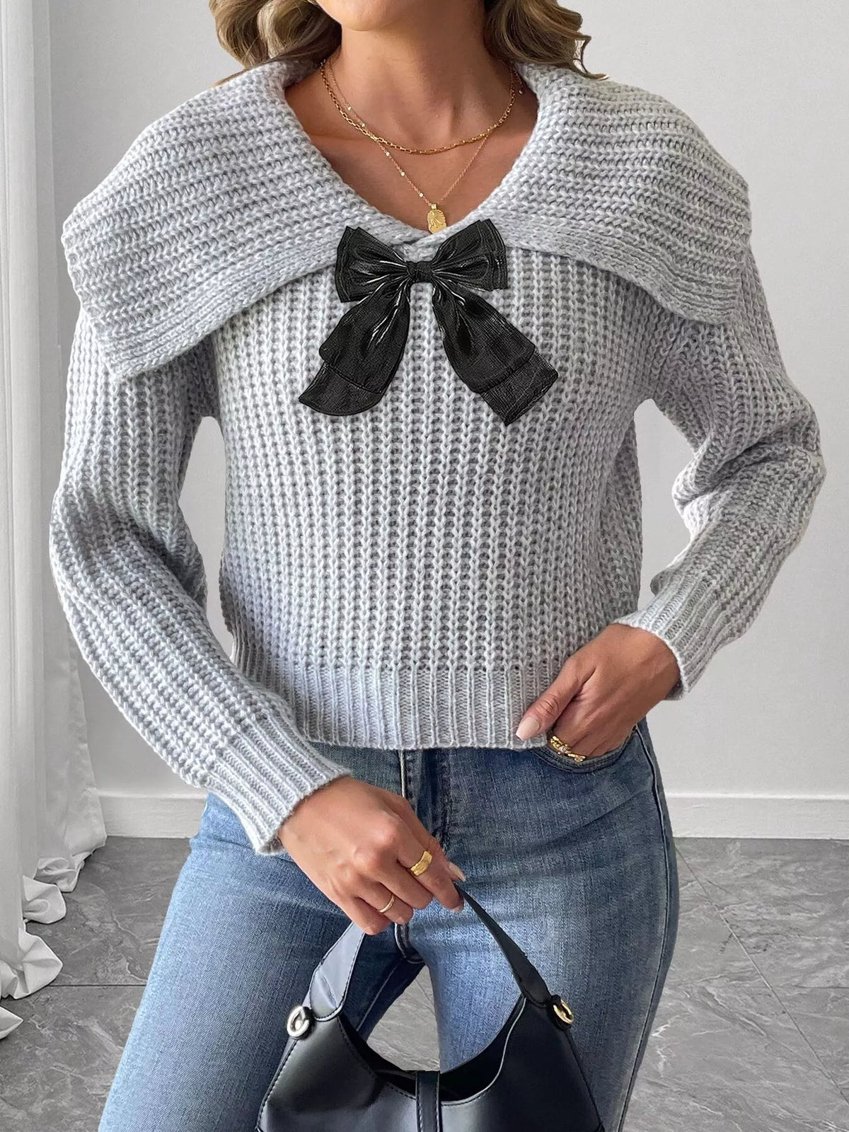 Contrast bow long sleeve sweater paired with a skirt, featuring a stylish design and Trendi brand label in the image.