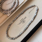 Pearl choker necklace by Shopimist featuring a string of elegant white pearls on a delicate chain.