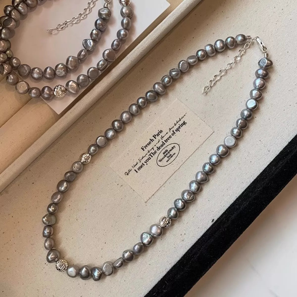 Pearl choker necklace by Shopimist featuring a string of elegant white pearls on a delicate chain.